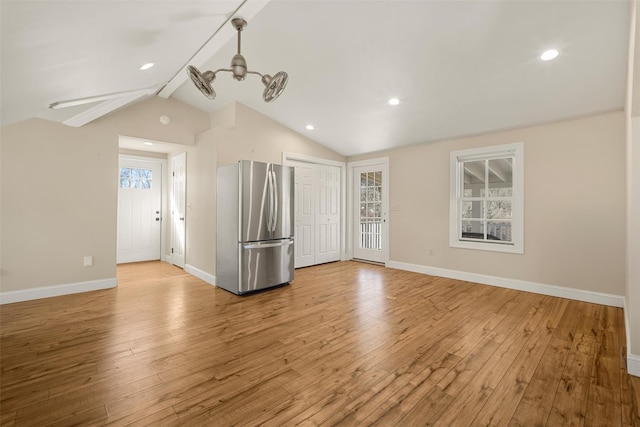 interior space featuring vaulted ceiling with beams, light wood finished floors, recessed lighting, and baseboards