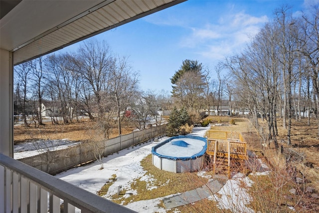 snow covered pool with a fenced in pool