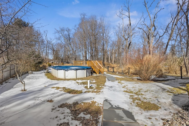 snowy yard with a covered pool