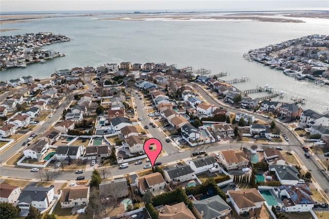 birds eye view of property featuring a water view and a residential view