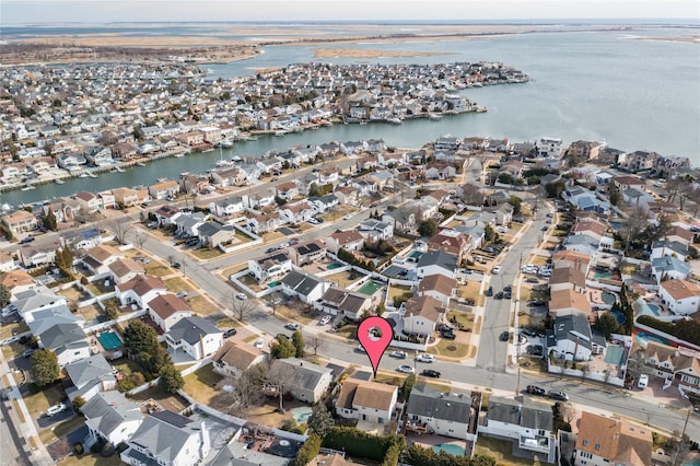 birds eye view of property featuring a water view and a residential view