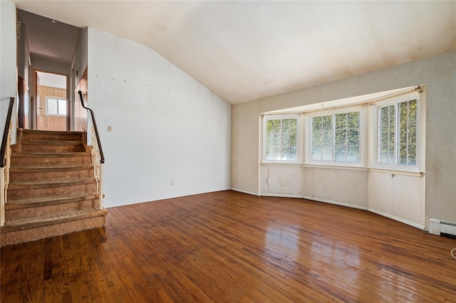 unfurnished living room featuring lofted ceiling, stairway, baseboard heating, and wood finished floors