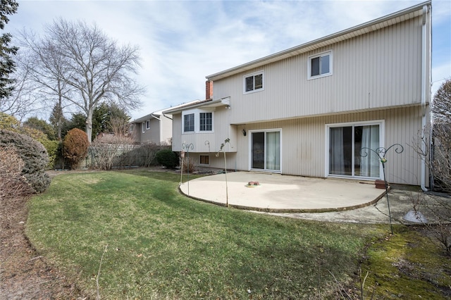 rear view of property featuring a yard, a patio area, and fence