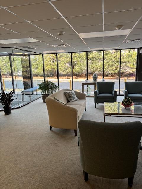 lobby featuring a sunroom and visible vents