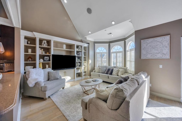 living area with high vaulted ceiling, baseboards, ornamental molding, and light wood finished floors