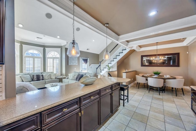 kitchen with vaulted ceiling with beams, ornamental molding, pendant lighting, and open floor plan