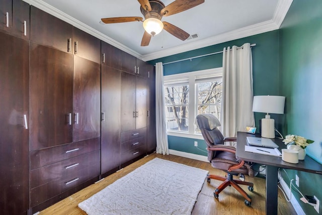 office space with ornamental molding, visible vents, light wood-style floors, and baseboards