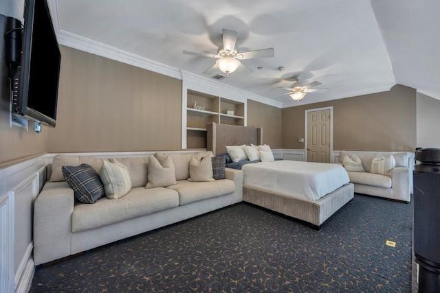 bedroom featuring ceiling fan, a wainscoted wall, vaulted ceiling, ornamental molding, and dark carpet