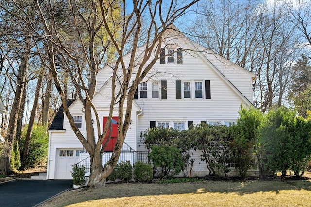 view of front of property with a garage, driveway, and a front yard