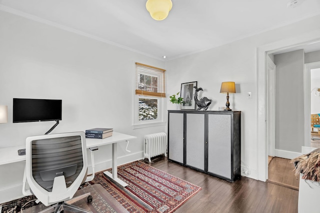 office space featuring baseboards, ornamental molding, wood finished floors, and radiator