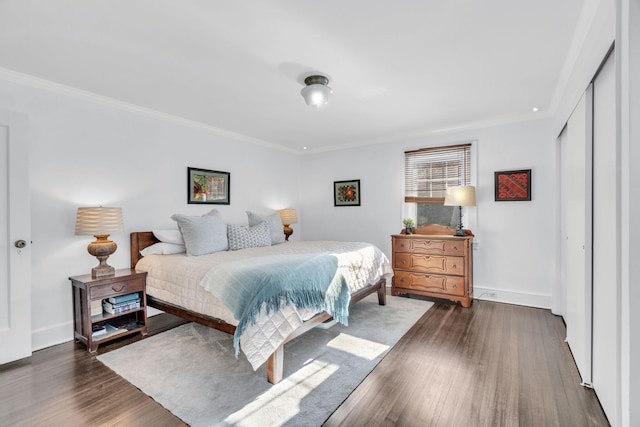 bedroom with baseboards, wood finished floors, and ornamental molding