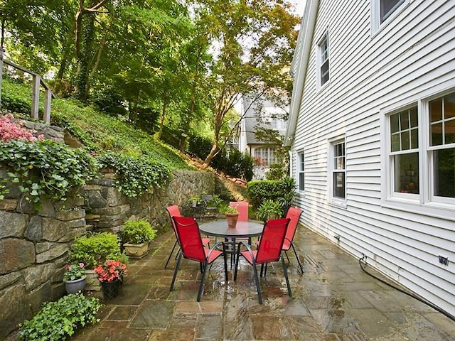 view of patio with fence and outdoor dining space