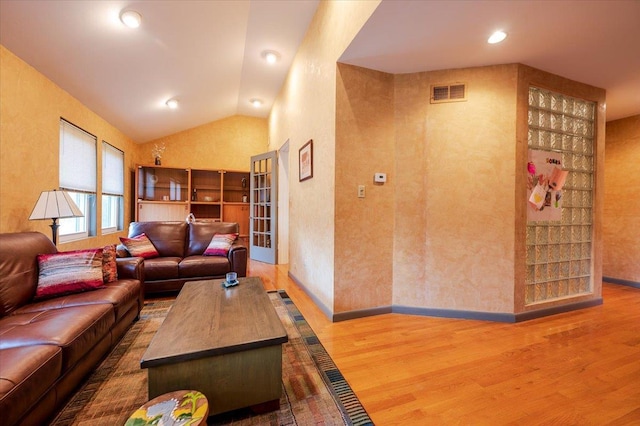 living room featuring baseboards, visible vents, wood finished floors, vaulted ceiling, and recessed lighting