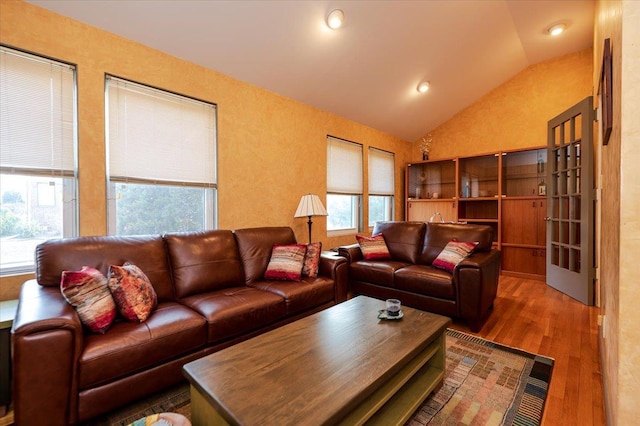 living room with recessed lighting, vaulted ceiling, and wood finished floors