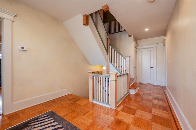 hall featuring recessed lighting, an upstairs landing, and baseboards