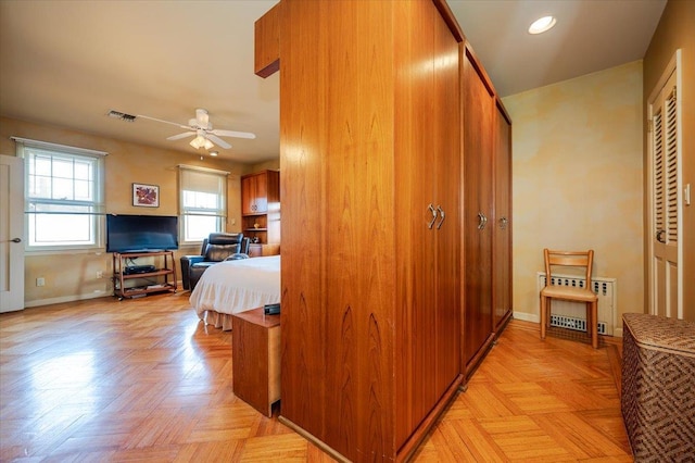 hall featuring baseboards, visible vents, and recessed lighting