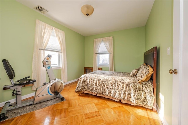bedroom featuring visible vents and baseboards