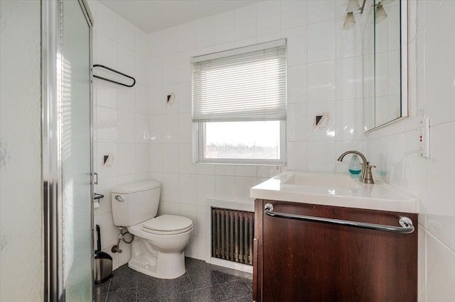 bathroom with vanity, tile walls, and radiator