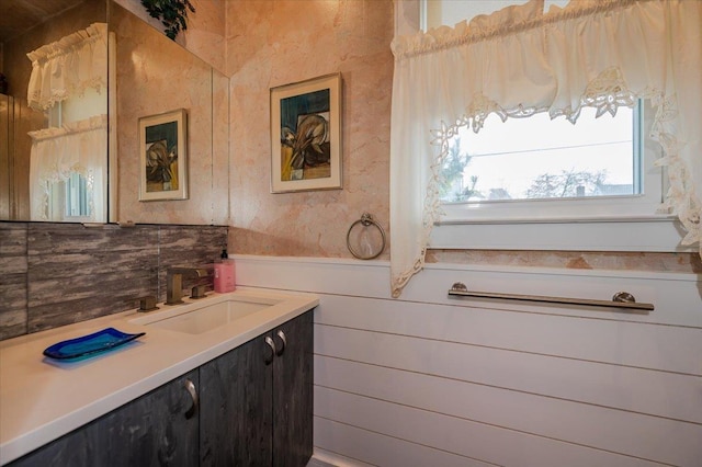 bathroom with a wainscoted wall and vanity