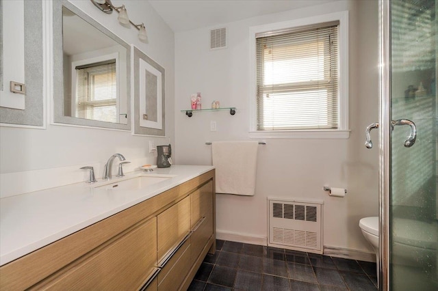 full bathroom featuring visible vents, radiator heating unit, toilet, a stall shower, and vanity