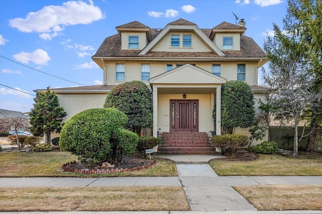 view of front of property with fence and stucco siding