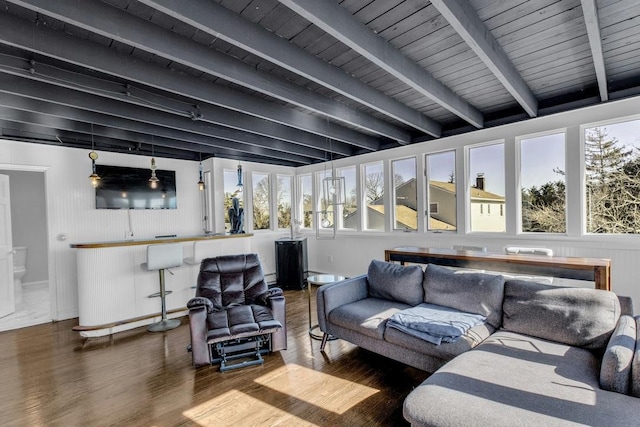 living room featuring a healthy amount of sunlight, wood ceiling, beam ceiling, and wood finished floors