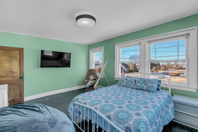 bedroom with dark wood-style flooring and baseboards