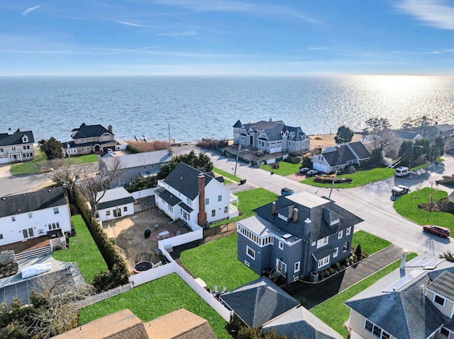 bird's eye view featuring a water view and a residential view