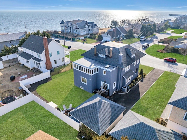 birds eye view of property with a water view and a residential view