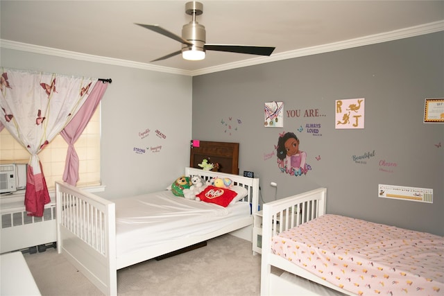 bedroom featuring ceiling fan, ornamental molding, radiator heating unit, and carpet