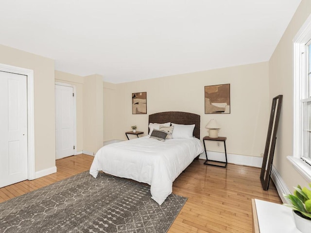 bedroom featuring light wood-style flooring and baseboards