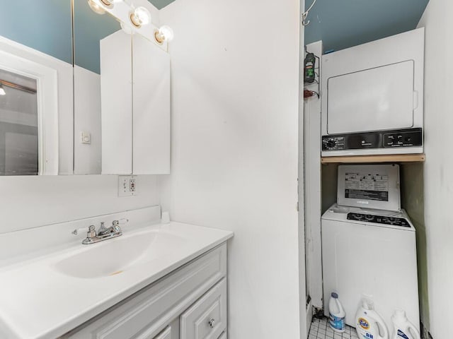 bathroom with vanity and stacked washer and clothes dryer