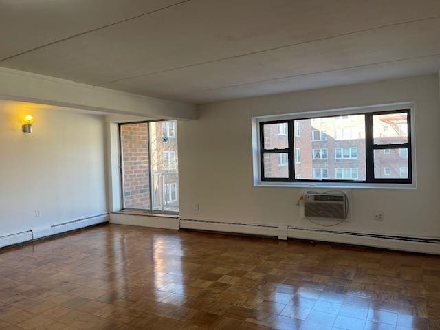 unfurnished room with baseboard heating, a wall mounted air conditioner, and a baseboard radiator