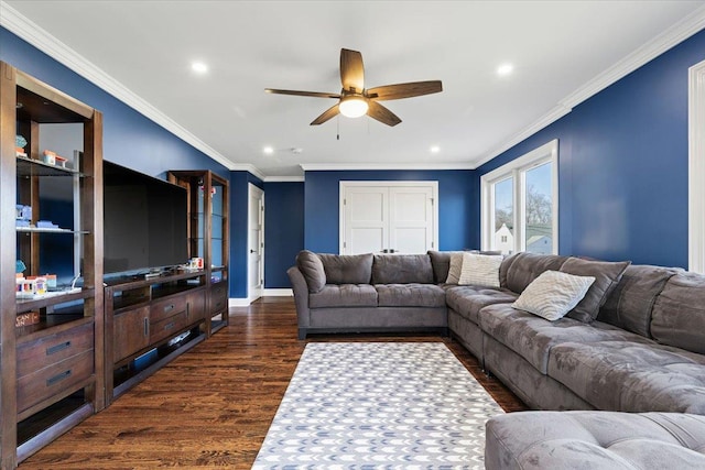 living room featuring baseboards, dark wood-type flooring, ceiling fan, and ornamental molding