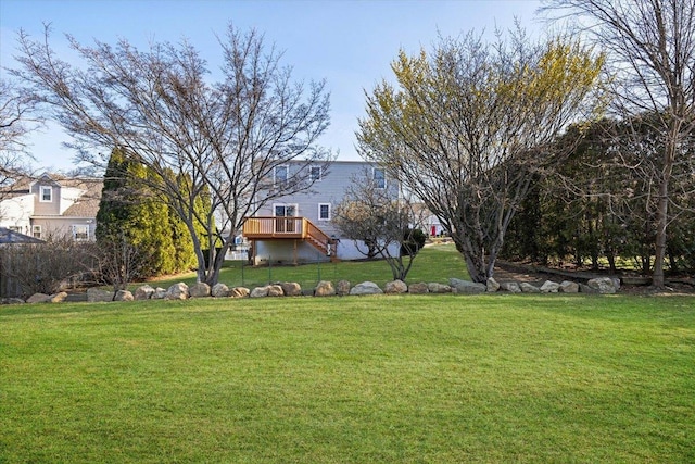 view of yard featuring a wooden deck and stairway