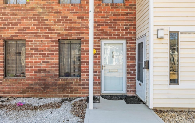 property entrance featuring brick siding