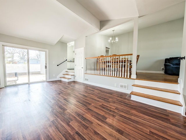 interior space featuring a notable chandelier, dark wood-type flooring, visible vents, baseboards, and stairs