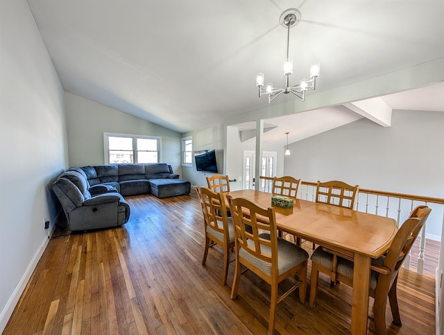 dining space with vaulted ceiling with beams, baseboards, hardwood / wood-style flooring, and a notable chandelier