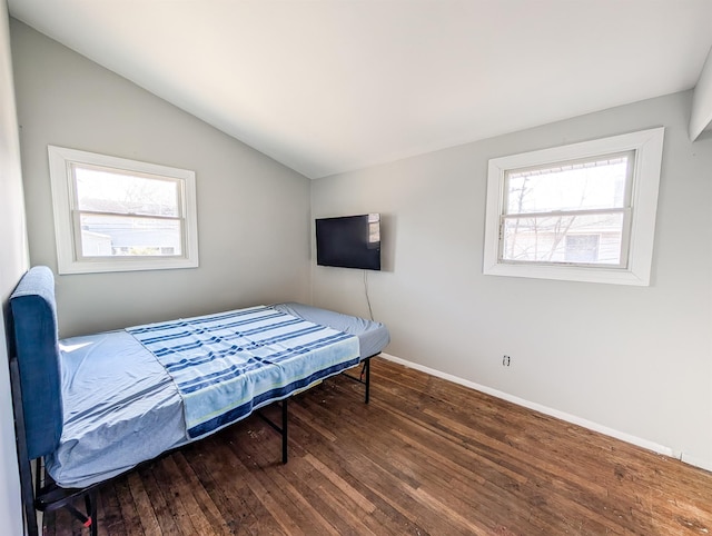 bedroom featuring dark wood-style flooring, multiple windows, vaulted ceiling, and baseboards