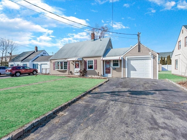 ranch-style home with a front lawn, driveway, a chimney, and a garage