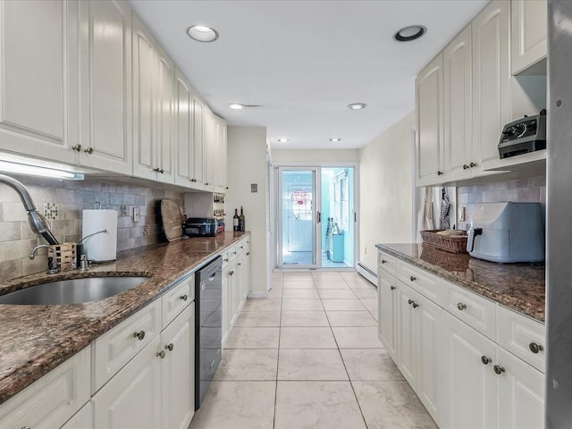 kitchen featuring a baseboard radiator, tasteful backsplash, dishwasher, and a sink