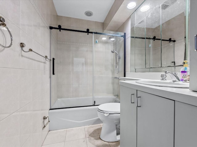 full bath featuring vanity, enclosed tub / shower combo, toilet, and tile patterned flooring