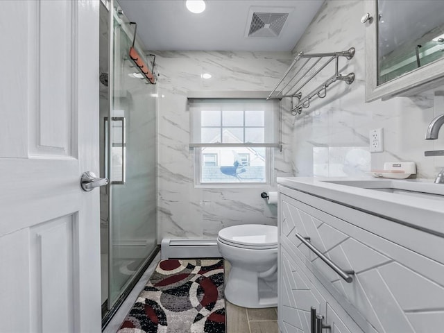 bathroom with visible vents, toilet, vanity, a marble finish shower, and a baseboard heating unit