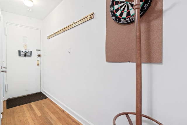 interior space with baseboards and wood finished floors