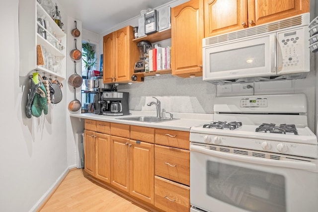 kitchen with open shelves, light countertops, backsplash, a sink, and white appliances