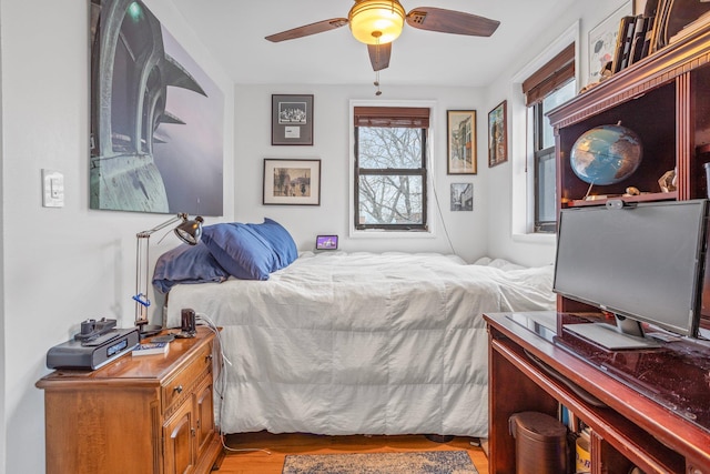 bedroom with light wood finished floors and ceiling fan