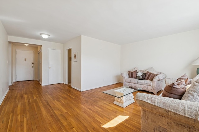 living area with wood finished floors and baseboards