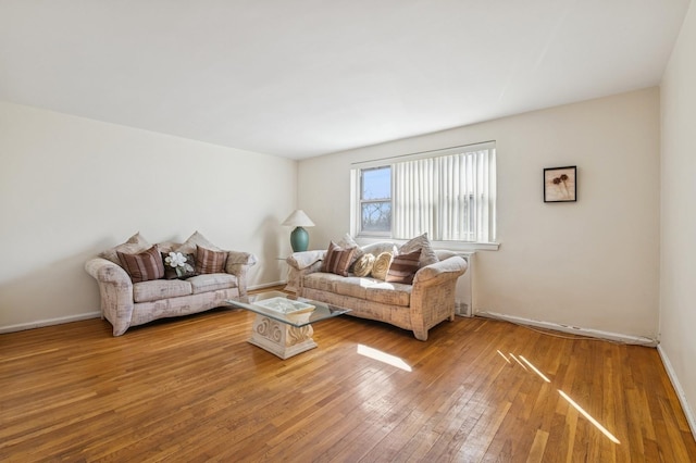 living room with hardwood / wood-style flooring and baseboards