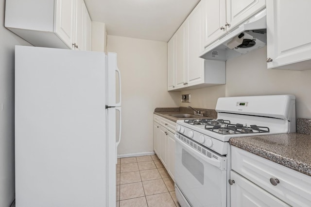 kitchen featuring under cabinet range hood, white appliances, a sink, white cabinets, and dark countertops