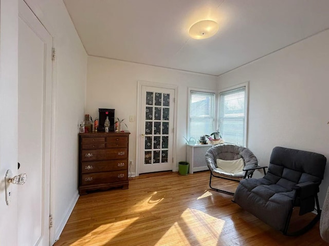 sitting room with light wood-style flooring and baseboards